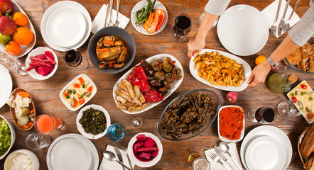 dinner table with many hands