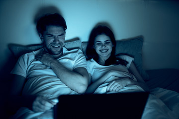Fototapeta premium couple sitting on sofa and watching tv