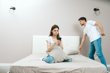 young couple sitting on sofa at home