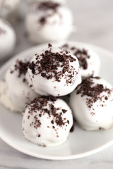A Pile of White Chocolate Covered Chocolate Sandwich Cookie Truffles
