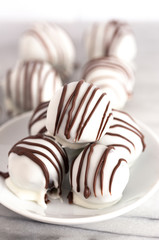 A Pile of White Chocolate Covered Chocolate Sandwich Cookie Truffles