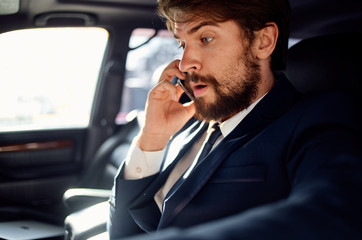 businessman talking on phone in car