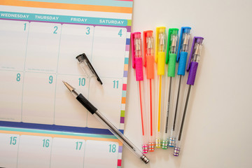 Calendar for planning and ideas writing with rainbow pens on the side