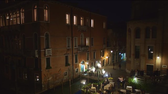 Venice, Italy - Ferry Boat Smoothly Sailing Over The Grand Canal With Historical Buildings Scenery At Night - Panoramic Shot