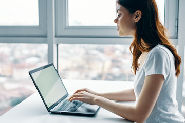 young woman working on her laptop at home