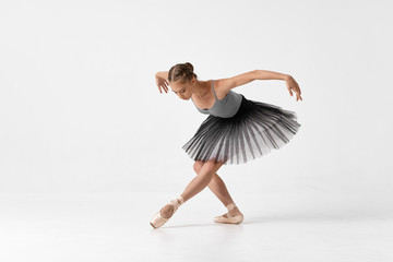 young ballet dancer posing on white background