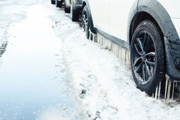 close up photo off car in iciles, a lot of water and snow, seasonal issues concept