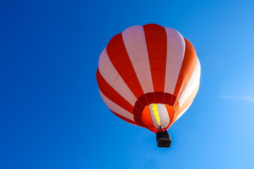Naklejka premium Colorful hot air balloon flying in the blue air sky