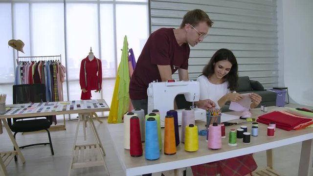 Slow motion female Fashion dressmaker work at home Self-employed Work on a table full of sewing equipment, both thread and sewing machines.