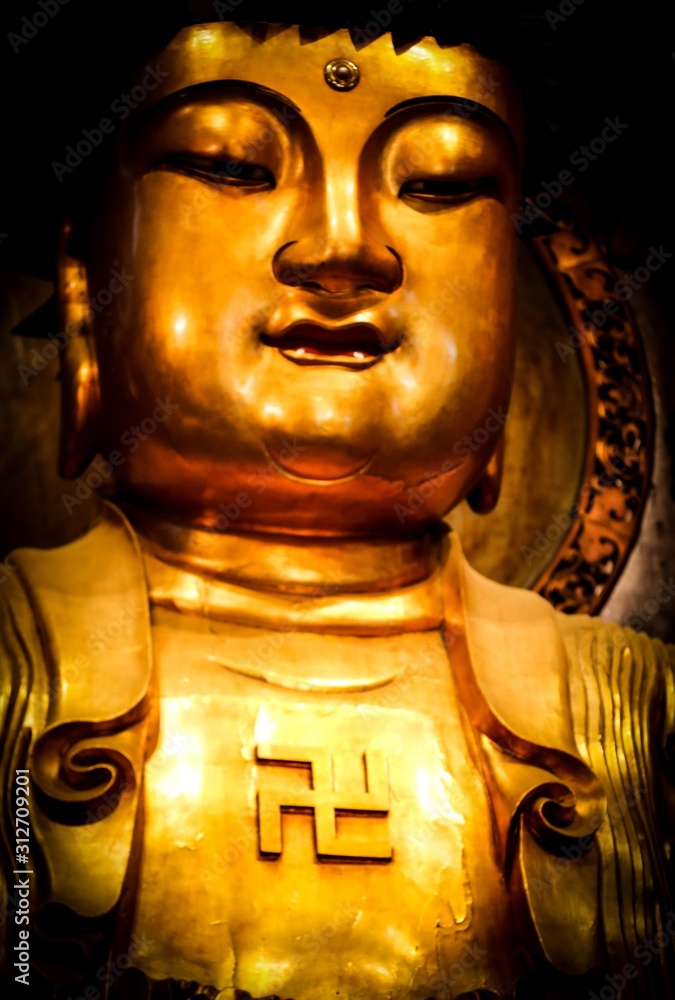 Poster swastika , buddha figure with a left facing swastika on his chest at the buddhist