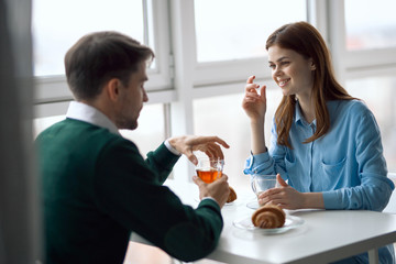 young couple having breakfast in the kitchen