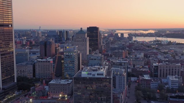 Aerial: Montreal City Skyline and Old Port at sunrise. Quebec, Canada