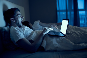 man sitting on sofa with laptop