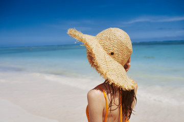 woman with hat on beach