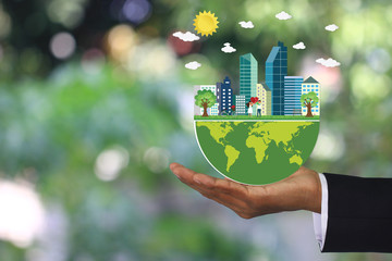 Man hand holding green world with Love couple holding heart shape stand in the meadows and a...