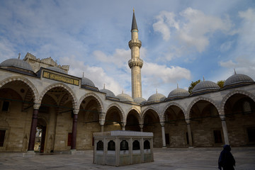 Minaret from inner courtyard with ablution fountain at Suleymaniye Mosque Istanbul Turkey