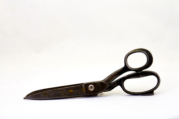 Old and warn pair of large rusted scissors isolated on a white background image in horizontal format with copy space