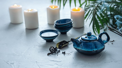 Obraz na płótnie Canvas Blue Tea Set For Chinese Tea Ceremony. Burning candles and scented couples.