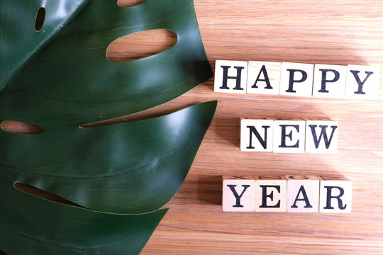 Wooden cube boxes show Happy New Year on wooden background