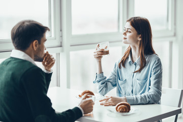 young couple having breakfast in the kitchen