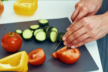 woman cutting vegetables in kitchen