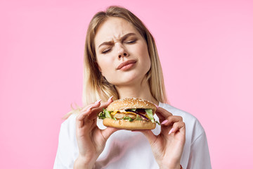 young woman eating hamburger