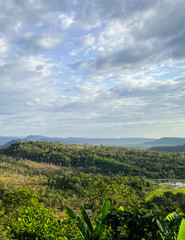 Fototapeta na wymiar Landscape view of forest, mountain, and cloudy sky at border of Thailand and Lao