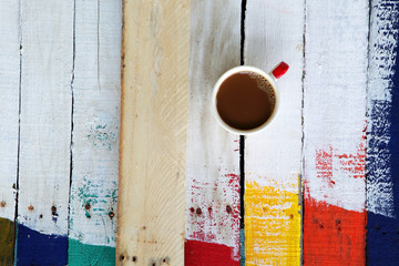 close up of hot coffee cup on colorful background