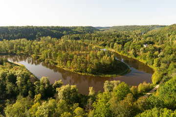 Fototapeta na wymiar Colorful autumn morning sunrise at forest covered picturesque Gauja river valley near Sigulda