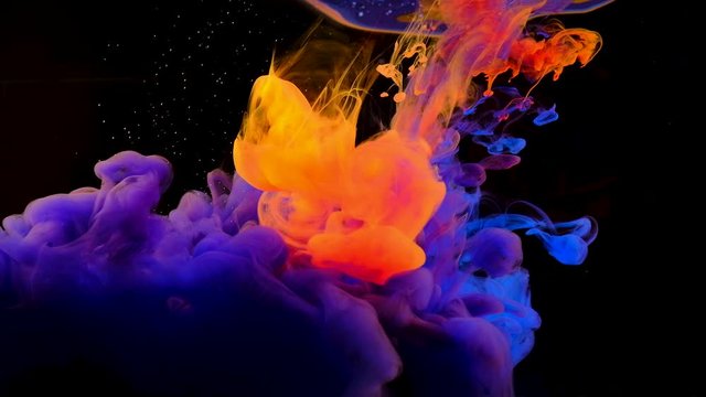 Color paint drops in water , abstract color mix , drop of Ink color mix paint falling on water Colorful ink in water, 4K footage,