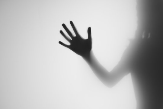 silhouette of hand on black background