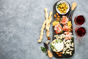 Cheese variety,  olives,  Prosciutto and wine
