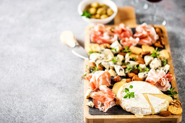 Cheese variety,  olives,  Prosciutto and wine