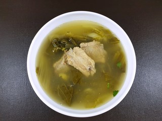Thai food style, Top view of pork meat soup with vegetables in white bowl on wooden table as a background, healthy food concept, Ready to eat
