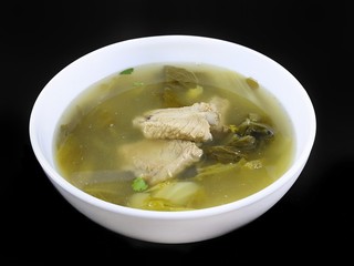 Thai food style, Top view of pork meat soup with vegetables in white bowl isolated on black background, healthy food concept, Ready to eat