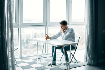 businessman sitting on chair and looking at camera