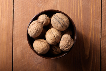 Walnuts in a small plate, top view