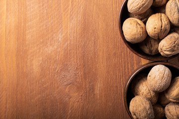Walnuts in small plates on the table, place for an inscription