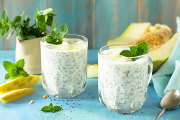 Healthy Pudding in a glass with Chia and melon and on blue stone  table. Healthy breakfast, vitamin...