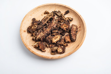 A plate of Chinese medicinal herbs tincture live on white background