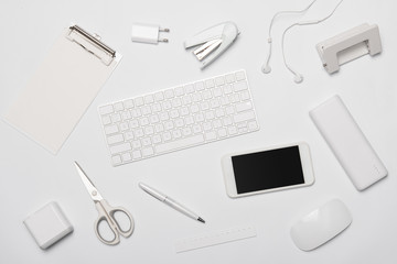 Top view of office and gadget supplies on white background