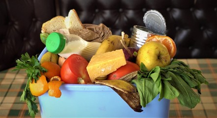 Household food waste. Uneaten spoiled foods in bin: bread, bakery, vegetables, fruits milk....