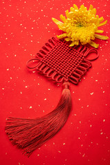 Ruyi knot and chrysanthemum on red background