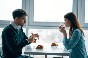 young couple having breakfast in the kitchen