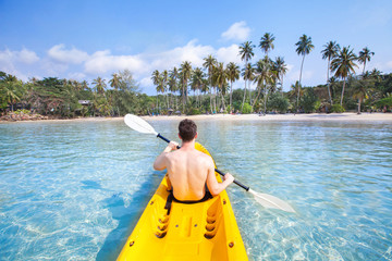 kayaking on tropical beach, travel to Asia, summer holidays, tourist paddling on kayak in turquoise sea water - obrazy, fototapety, plakaty