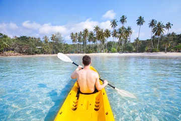 Foto op Canvas kayaking on tropical beach, travel to Asia, summer holidays, tourist paddling on kayak in turquoise sea water © Song_about_summer