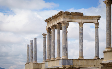 Obraz premium Scaenae frons in the Antique Roman Theatre in Merida. Panorama image. The Archaeological Ensemble of Merida is declared a UNESCO World Heritage Site Ref 664. Orange and teal style