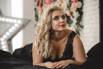 Nice plus size woman in bedroom, femininity and modern lady concept 