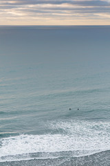 Two surfer in vast ocean