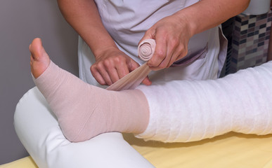 Lymphedema management: Wrapping leg using multilayer bandages to control Lymphedema. Part of complete decongestive therapy (cdt) and manual lymphatic drainage (MLD)